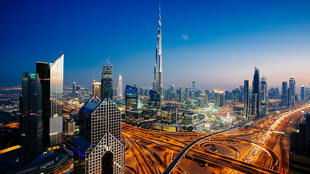 Modern Dubai skyline featuring the Burj Khalifa and city lights at sunset.