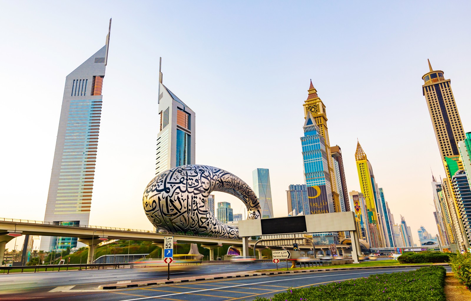 Futuristic skyline of Dubai featuring the Museum of the Future and modern skyscrapers along Sheikh Zayed Road.