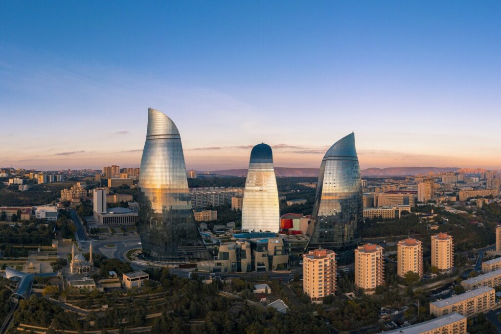Flame Towers Baku illuminated at night with colorful lights overlooking the Caspian Sea Baku